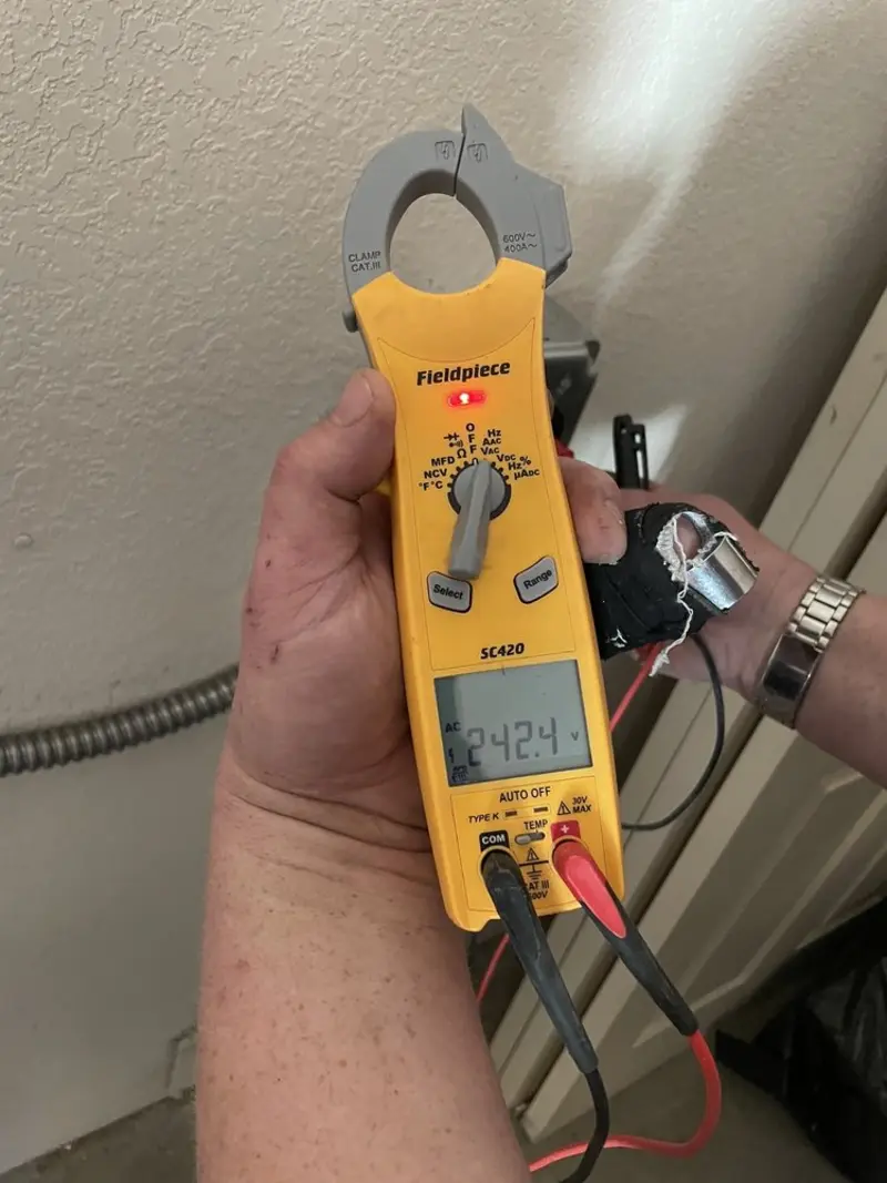 Voltage testing with clamp meter during Electrical Installation Services in Geneva